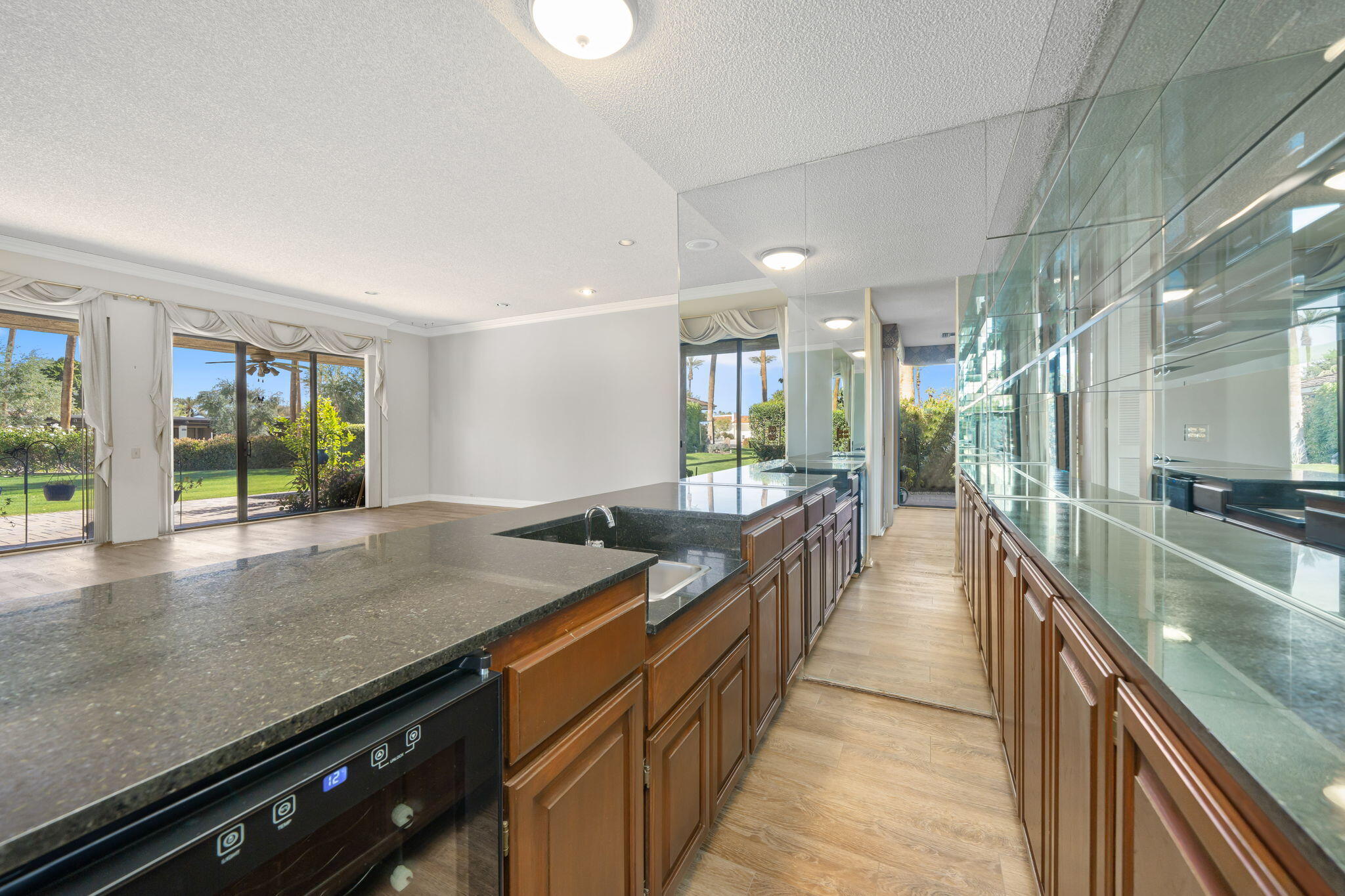 140 Columbia Drive Rancho Mirage, CA 92270 - Photo 5 of 31 a large kitchen with kitchen island a large window
