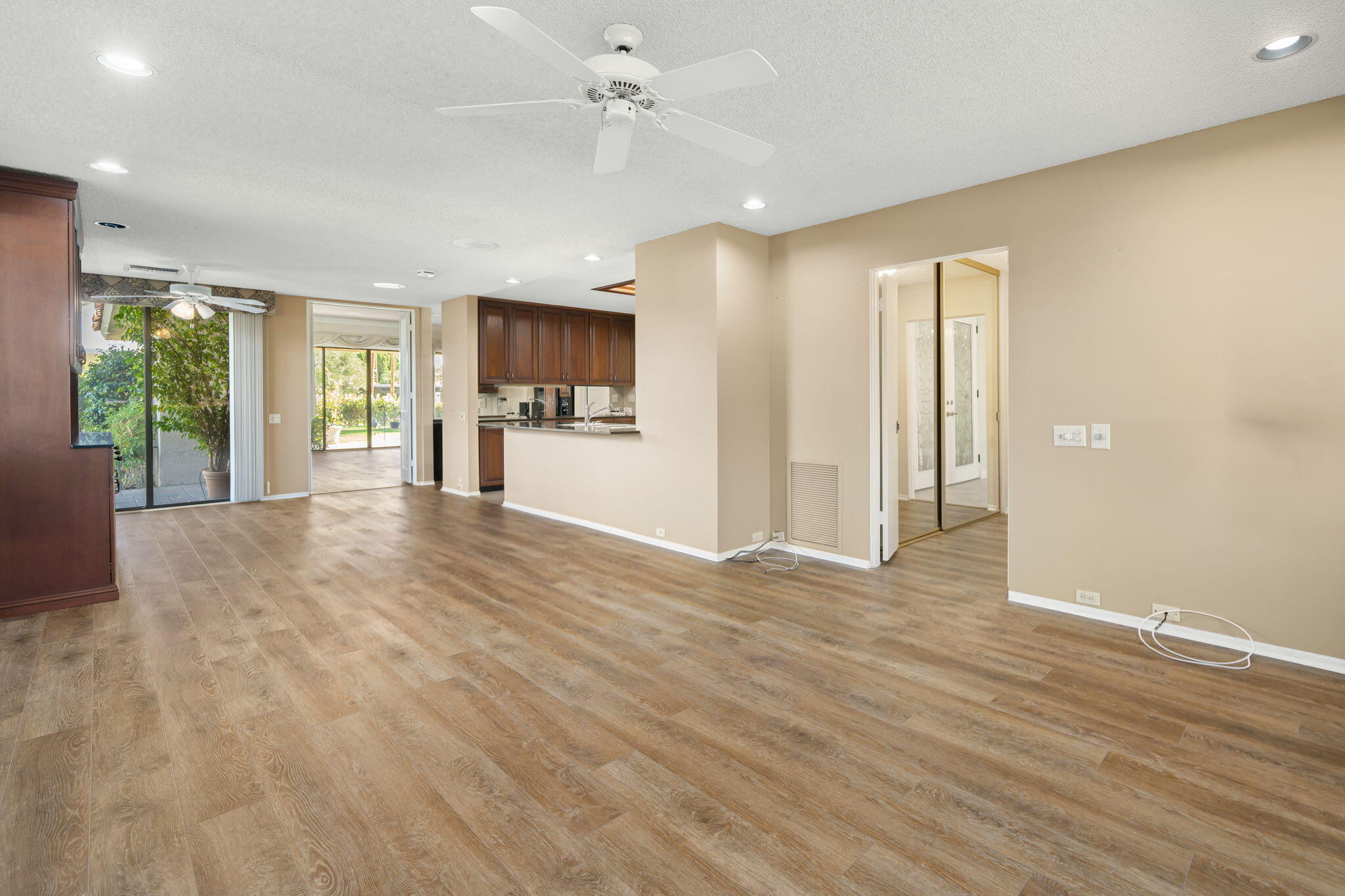 140 Columbia Drive Rancho Mirage, CA 92270 - Photo 7 of 31 a view of a kitchen with a stove cabinets and a wooden floor