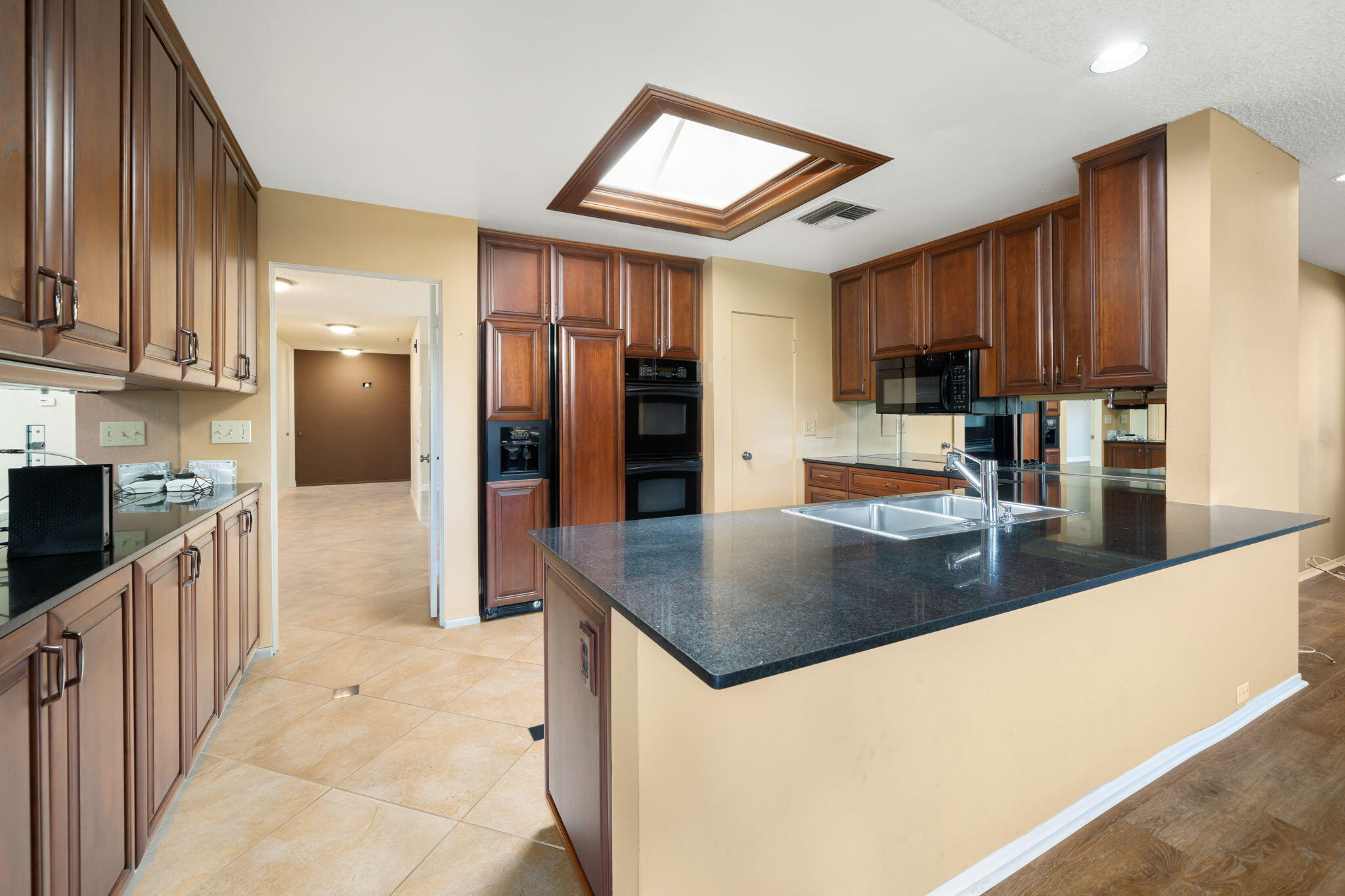 140 Columbia Drive Rancho Mirage, CA 92270 - Photo 8 of 31 a kitchen with stainless steel appliances granite countertop a sink a stove and a refrigerator