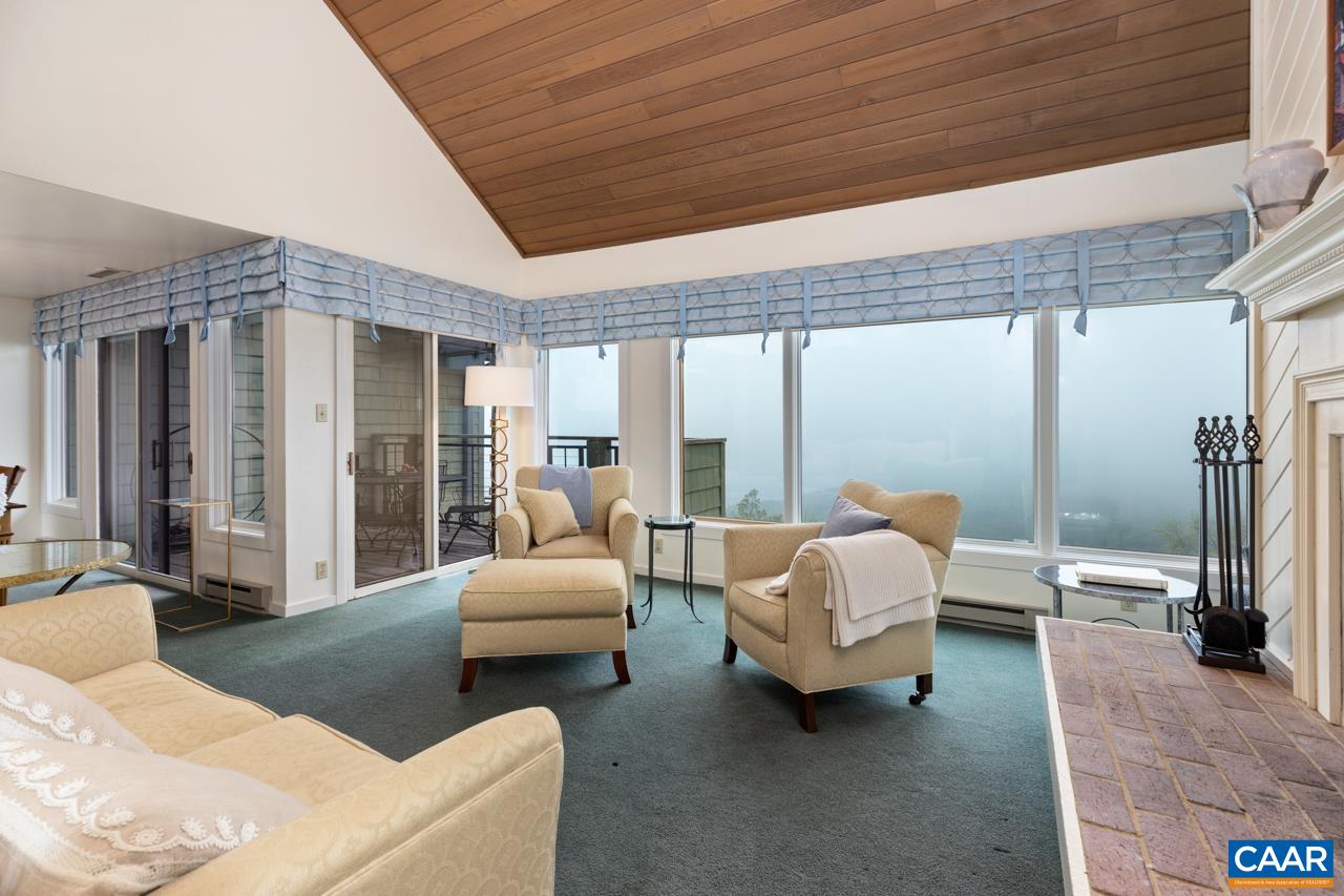 a living room with furniture and large windows