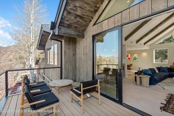 a living room with furniture fireplace and a large window