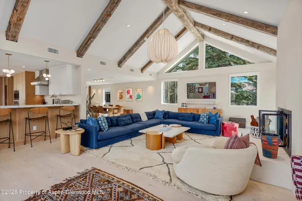 a living room with furniture a fireplace and a large window