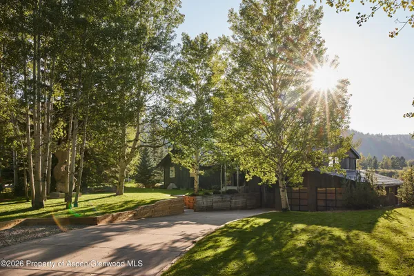 a bathroom with a glass door shower and a sink