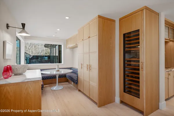 a bedroom with a bed and glass walk in closet