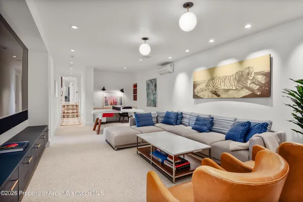 a view of a livingroom with furniture and a bookshelf