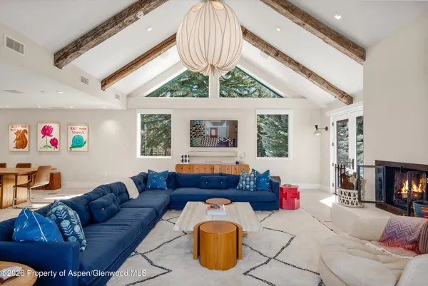 a living room with furniture a rug and a large window