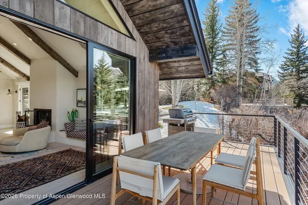 a living room with furniture a large window with kitchen view