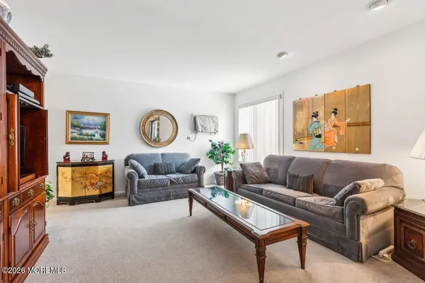 a living room with furniture and a floor to ceiling window