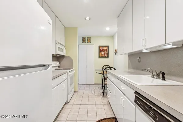 a kitchen with a sink cabinets and appliances