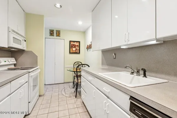 a kitchen with a refrigerator and cabinets