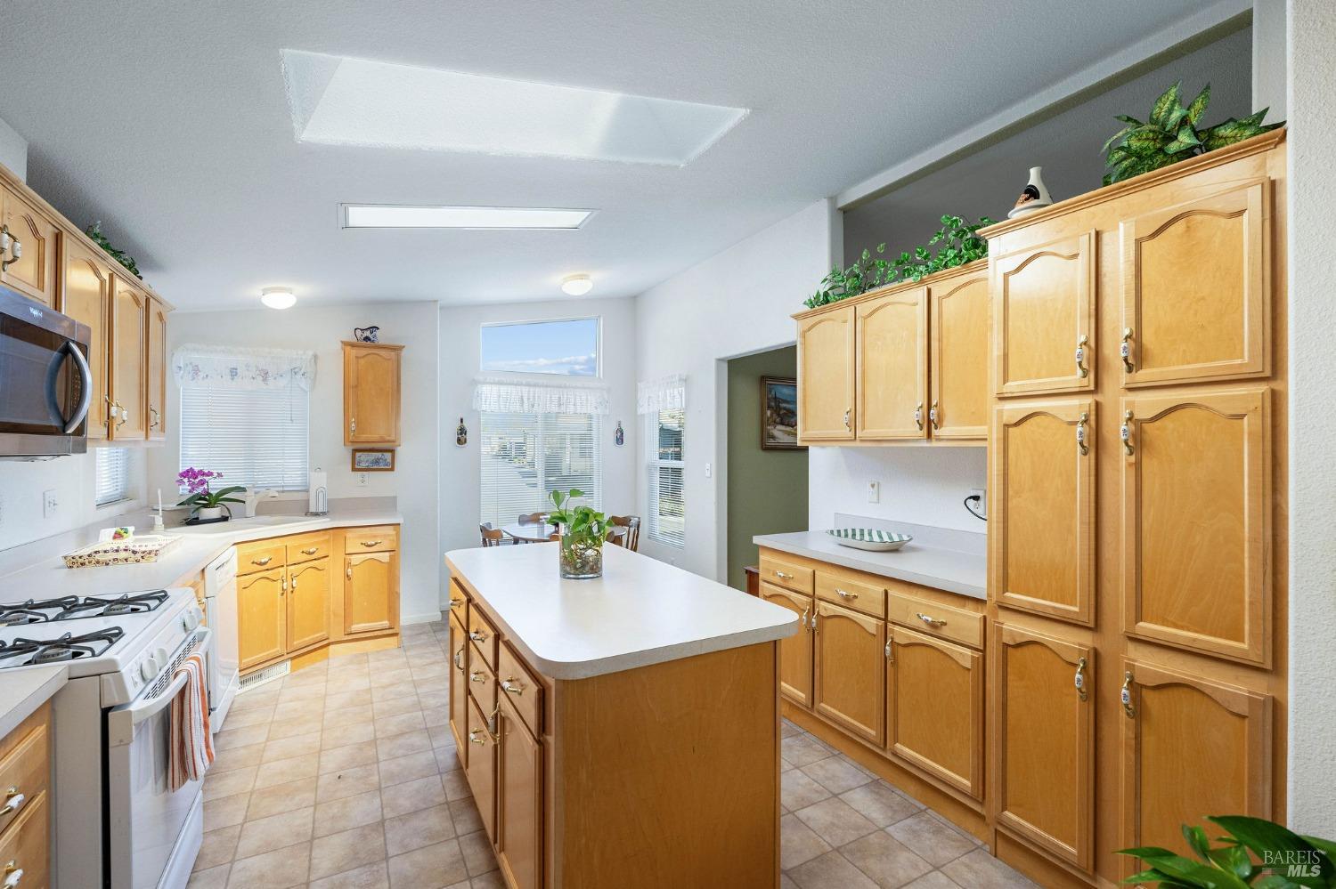 6468 Washington Street, Unit 16 Yountville, CA 94599 - Photo 18 of 45 a kitchen with a refrigerator a sink a stove top oven and cabinets