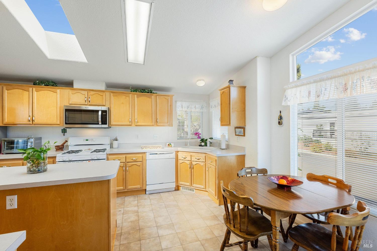 6468 Washington Street, Unit 16 Yountville, CA 94599 - Photo 21 of 45 a kitchen with a stove a refrigerator and a dining table