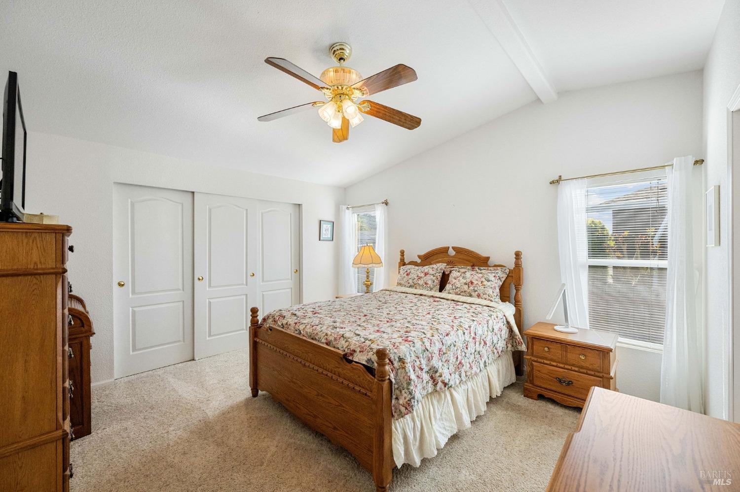 6468 Washington Street, Unit 16 Yountville, CA 94599 - Photo 24 of 45 a bedroom with a bed and a chandelier