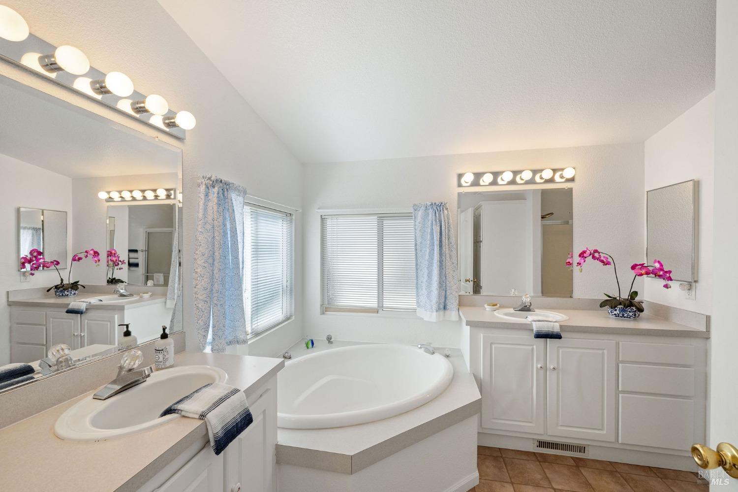 6468 Washington Street, Unit 16 Yountville, CA 94599 - Photo 27 of 45 a bathroom with a sink vanity tub and a mirror