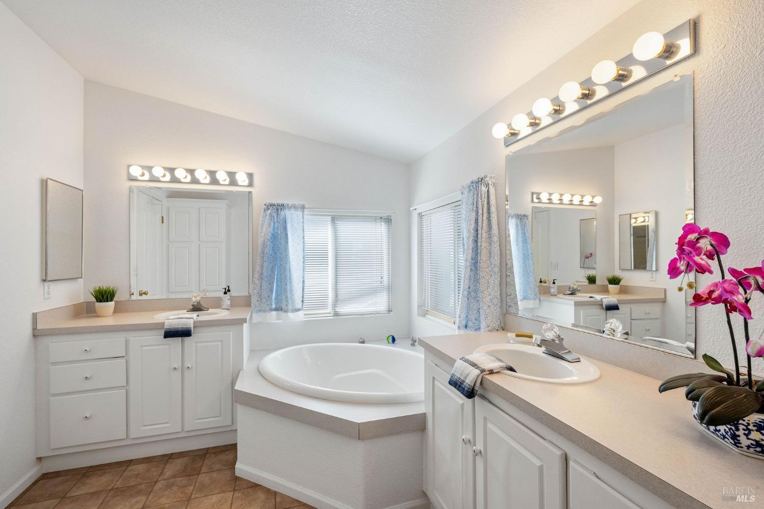 6468 Washington Street, Unit 16 Yountville, CA 94599 - Photo 28 of 45 a en suite bathroom with a sink double vanity granite and a mirror