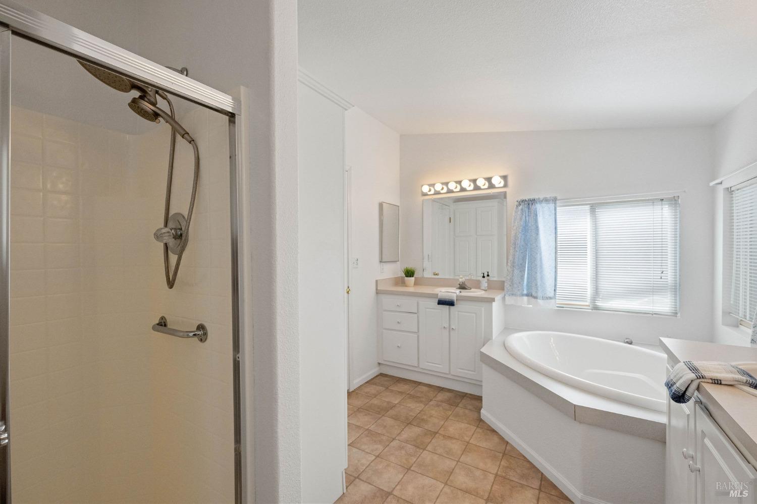 6468 Washington Street, Unit 16 Yountville, CA 94599 - Photo 29 of 45 a bathroom with a granite countertop sink a toilet and shower