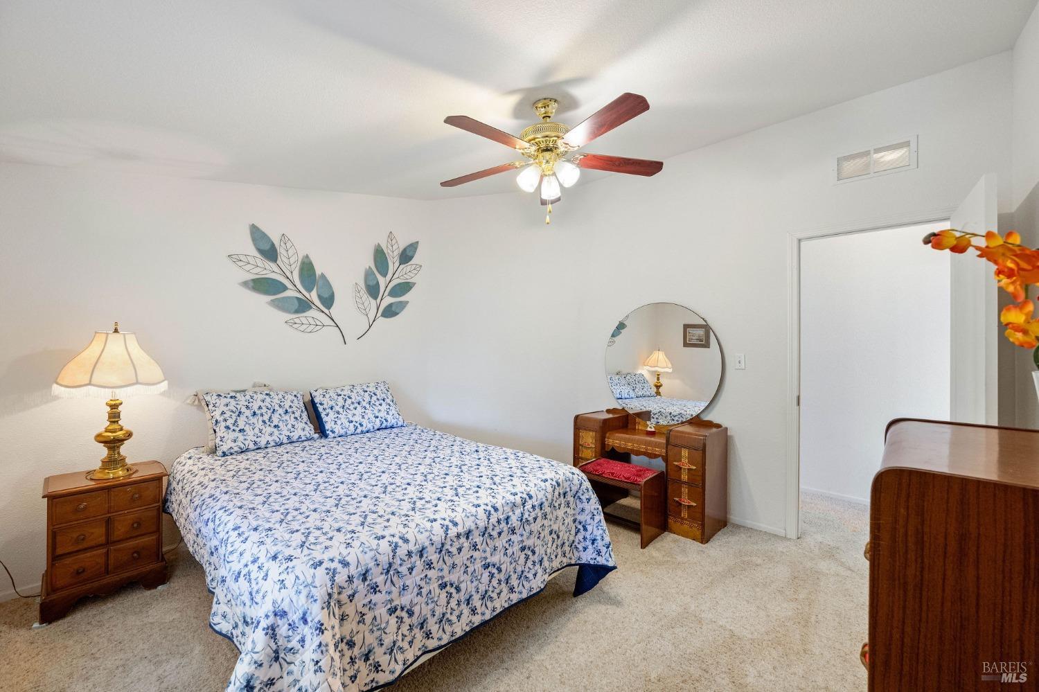 6468 Washington Street, Unit 16 Yountville, CA 94599 - Photo 32 of 45 a bedroom with a bed and a chandelier