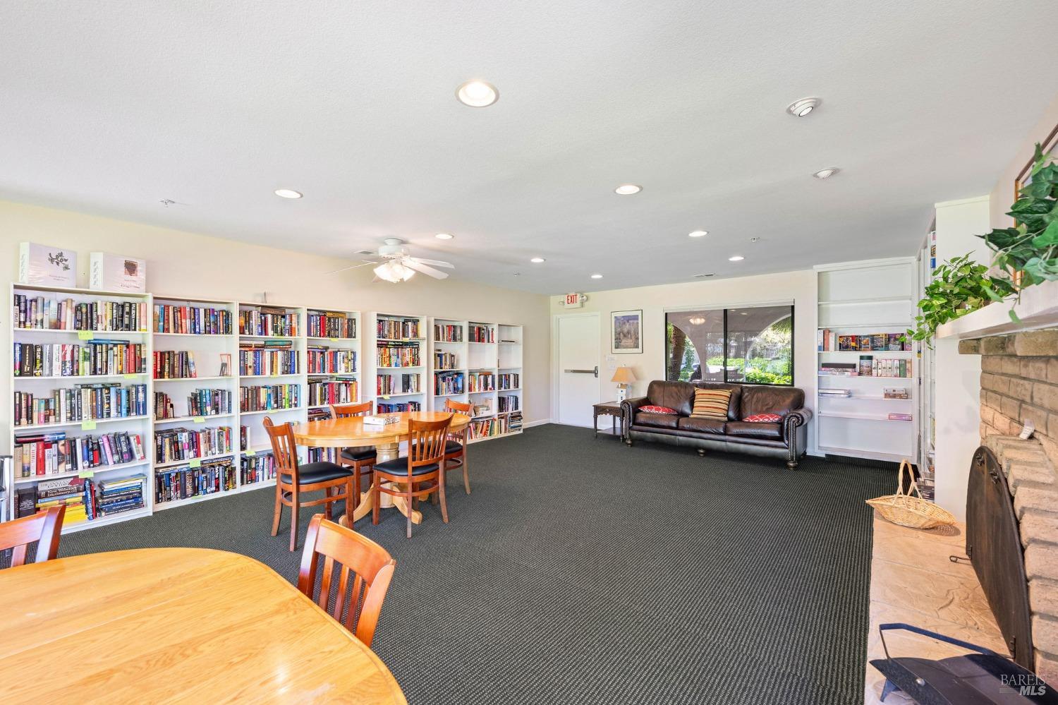 6468 Washington Street, Unit 16 Yountville, CA 94599 - Photo 38 of 45 a living room with furniture a fireplace and bookshelf
