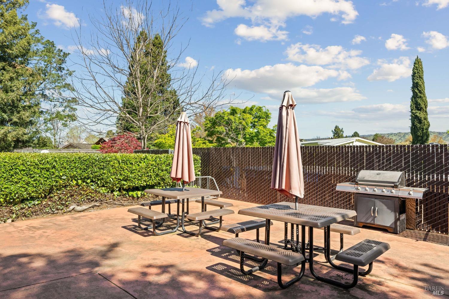 6468 Washington Street, Unit 16 Yountville, CA 94599 - Photo 45 of 45 a view of a patio with a table chairs and a fire pit