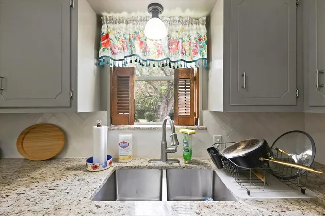 a kitchen with a stove a sink and a microwave