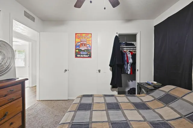 a room with a black white checkered floor with a rug