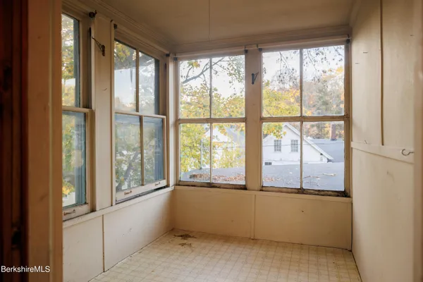 a bed sitting in a bedroom next to a window