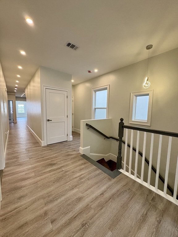 54 Falcon Street, Unit 2 Boston, MA 02128 - Photo 13 of 21 a view of a hallway with wooden floor and windows