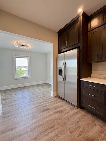 a kitchen with granite countertop stainless steel appliances a refrigerator and microwave