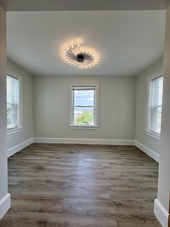 54 Falcon Street, Unit 2 Boston, MA 02128 - Photo 3 of 21 a view of an empty room with wooden floor and a window
