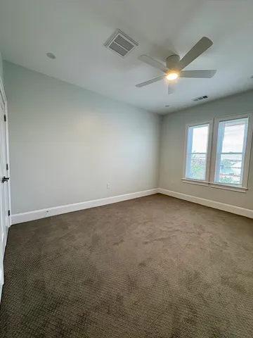 an empty room with a empty space and windows