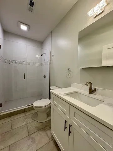 a bathroom with a sink toilet and shower