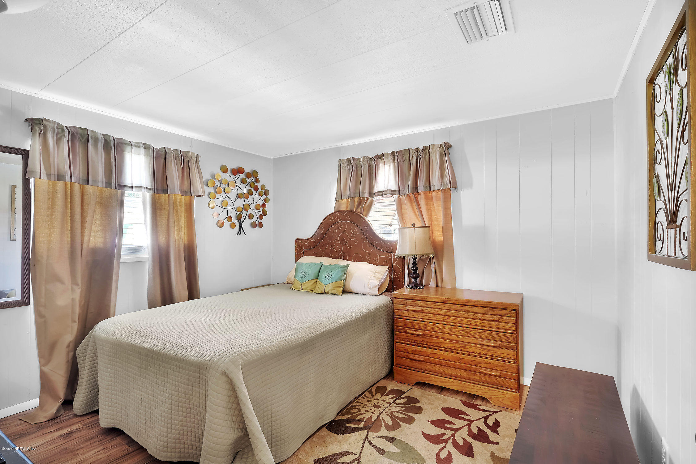 890 Palermo Road St. Augustine, FL 32086 - Photo 17 of 25 a bedroom with a bed and a window