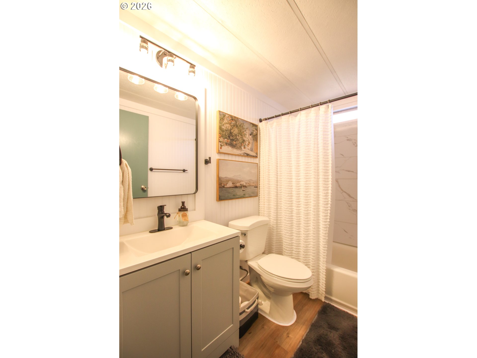 1431 Maple Street Florence, OR 97439 - Photo 24 of 43 a bathroom with a toilet a sink and a mirror