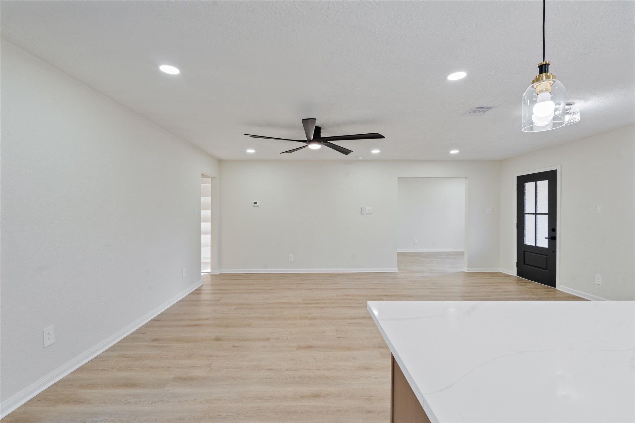 10403 Winding Trail Road La Porte, TX 77571 - Photo 11 of 26 a view of an empty room with wooden floor and a ceiling fan
