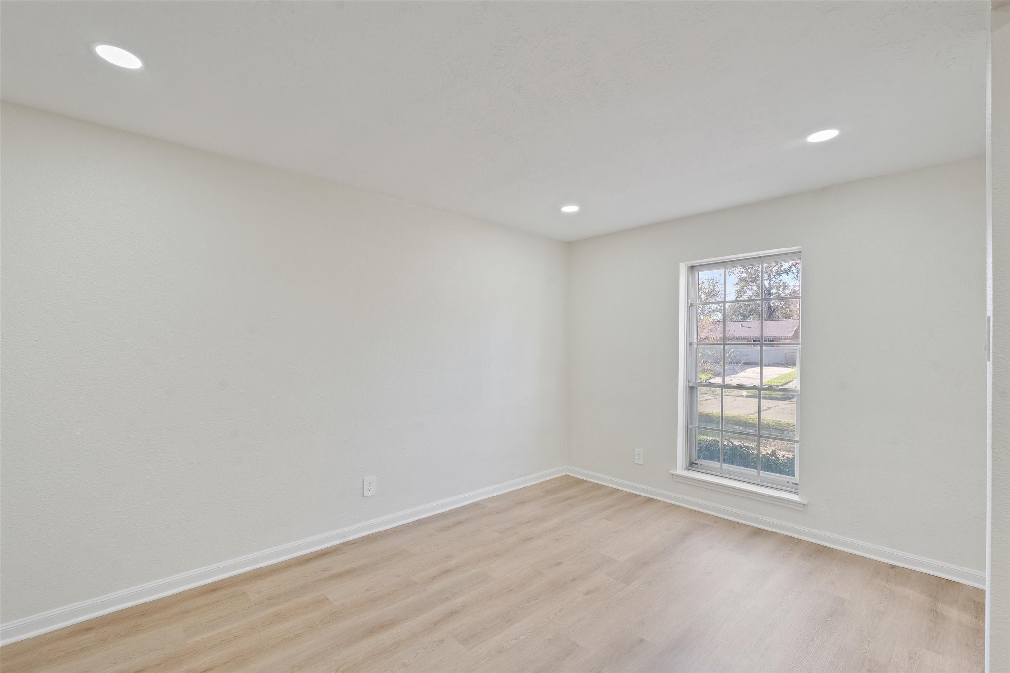 10403 Winding Trail Road La Porte, TX 77571 - Photo 13 of 26 an empty room with wooden floor and windows