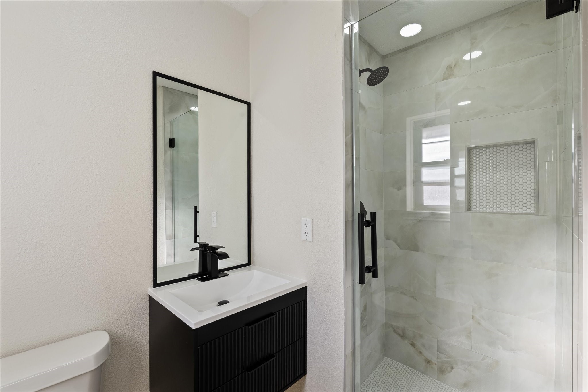 10403 Winding Trail Road La Porte, TX 77571 - Photo 19 of 26 a bathroom with a sink a toilet and mirror