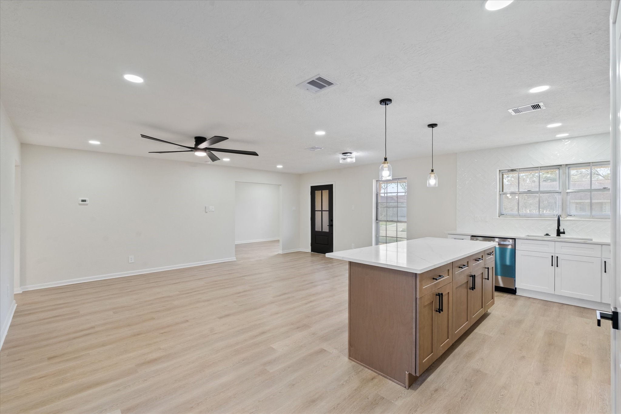 10403 Winding Trail Road La Porte, TX 77571 - Photo 8 of 26 a large kitchen with kitchen island a stove a sink a center island and wooden floor