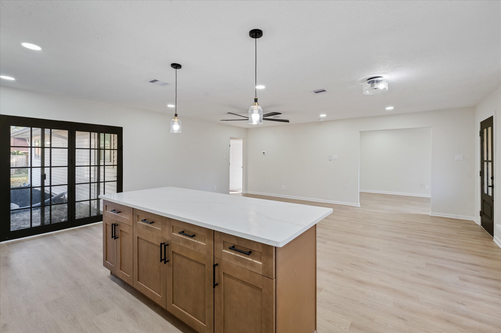 10403 Winding Trail Road La Porte, TX 77571 - Photo 10 of 26 a hall with kitchen island a stove a sink dishwasher and a oven with wooden floor