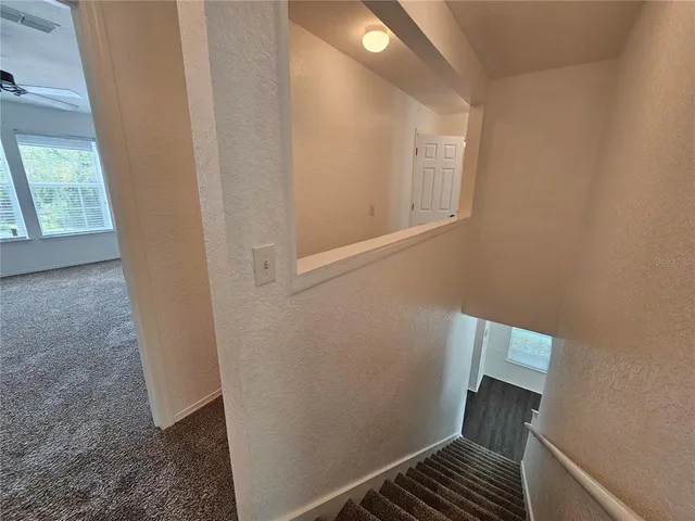 a view of a livingroom with a ceiling fan and window