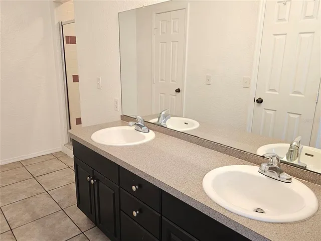 a bathroom with a sink double vanity and a mirror