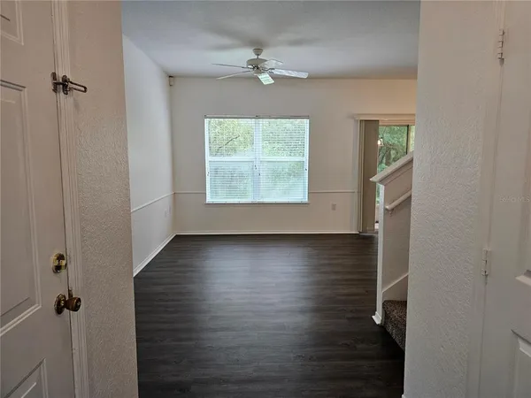 wooden floor in an empty room with a window
