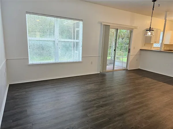 a view of a kitchen with wooden floor and a window