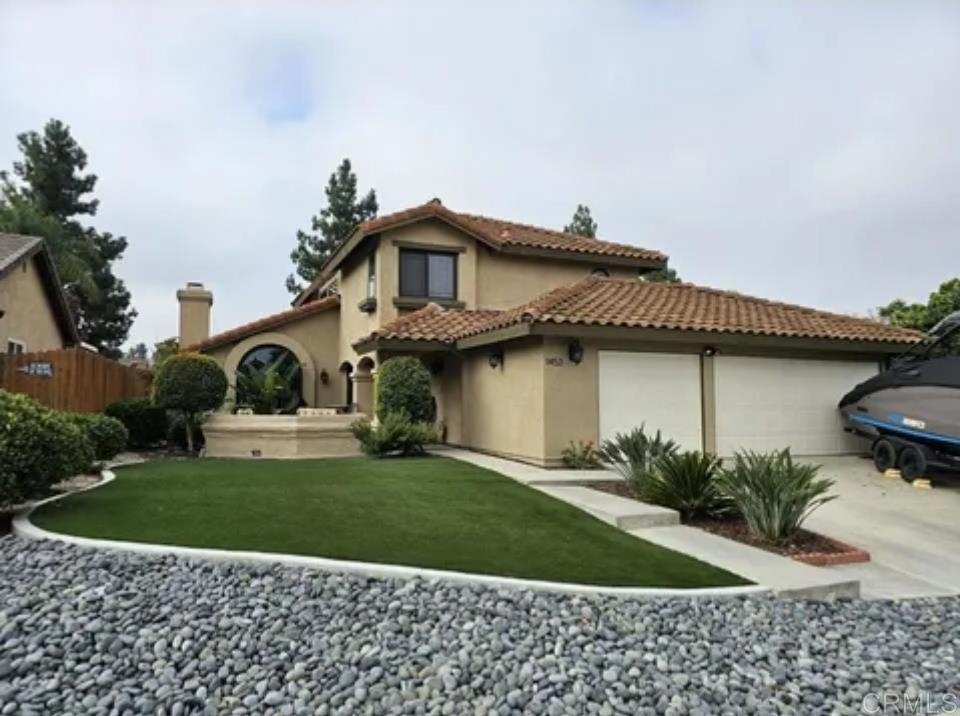 1453 Powell Road Oceanside, CA 92056 - Photo 1 of 1 a front view of a house with a garden