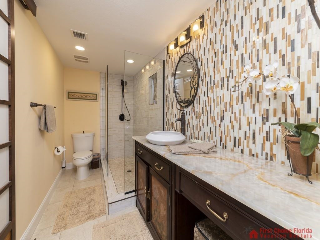 1 Dondanville Road, Unit 109B St. Augustine, FL 32080 - Photo 15 of 27 a bathroom with a granite countertop sink a toilet a mirror and shower