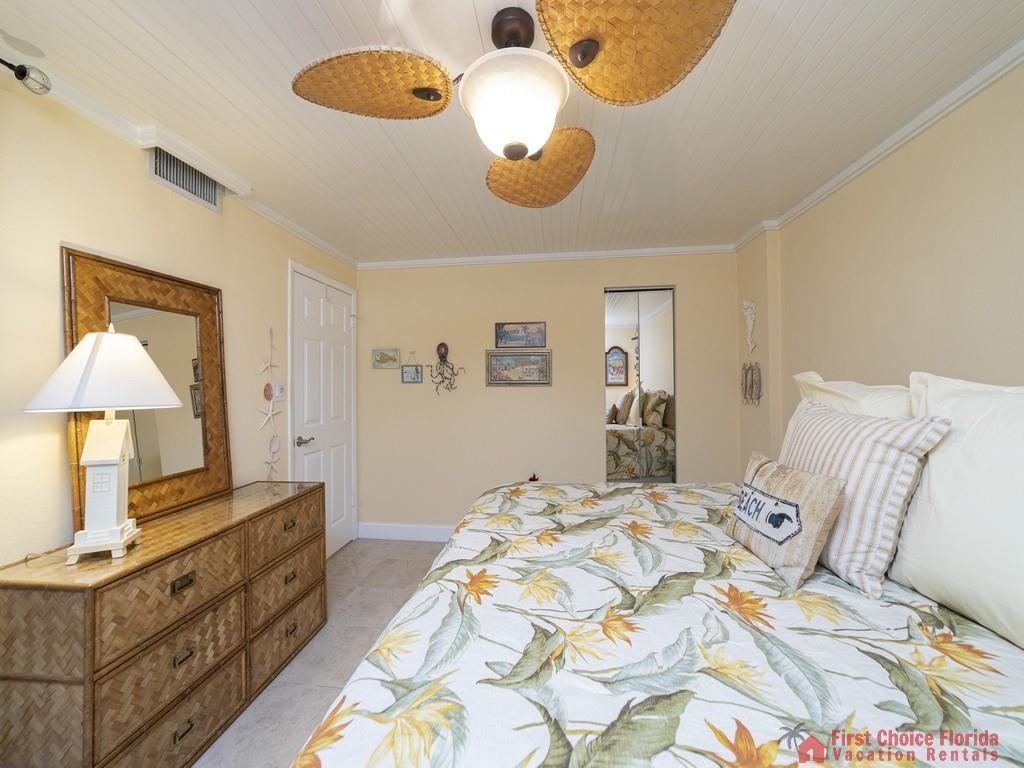1 Dondanville Road, Unit 109B St. Augustine, FL 32080 - Photo 19 of 27 a bedroom with a bed and a chandelier