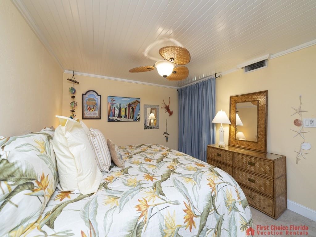 1 Dondanville Road, Unit 109B St. Augustine, FL 32080 - Photo 20 of 27 a bedroom with a bed and a chandelier