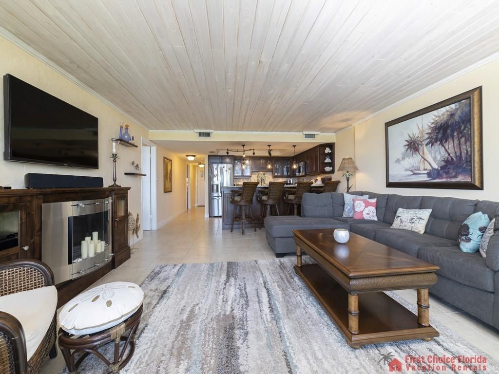 1 Dondanville Road, Unit 109B St. Augustine, FL 32080 - Photo 2 of 27 a living room with furniture a flat screen tv and a fireplace