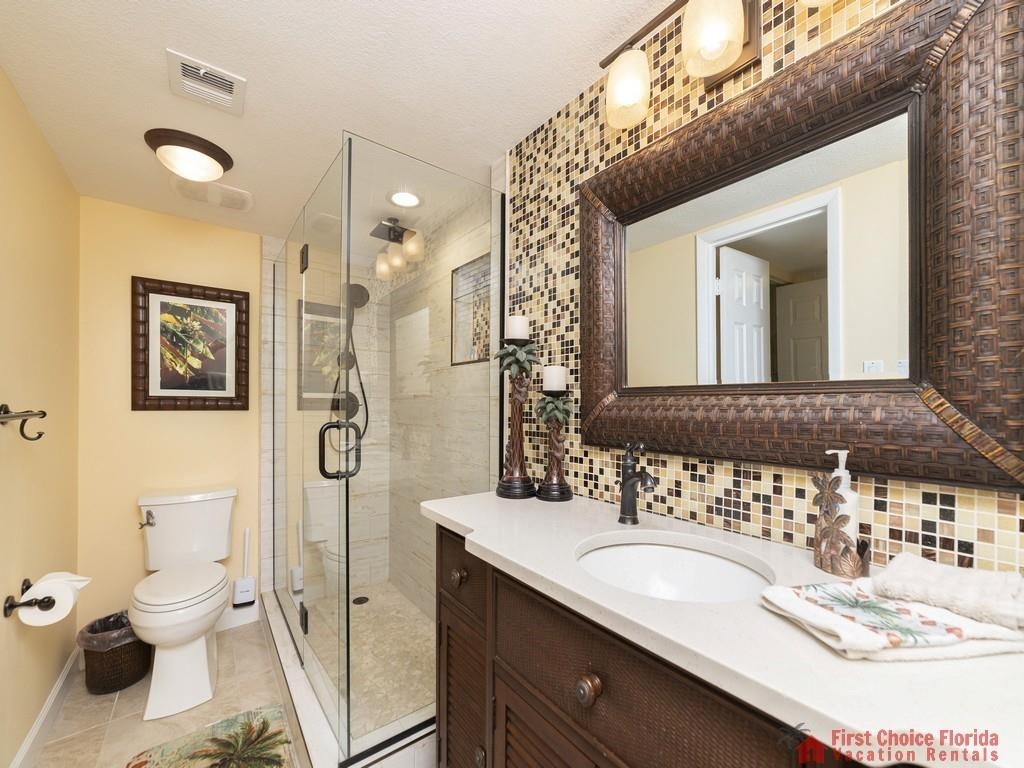 1 Dondanville Road, Unit 109B St. Augustine, FL 32080 - Photo 21 of 27 a bathroom with a granite countertop sink mirror and a toilet