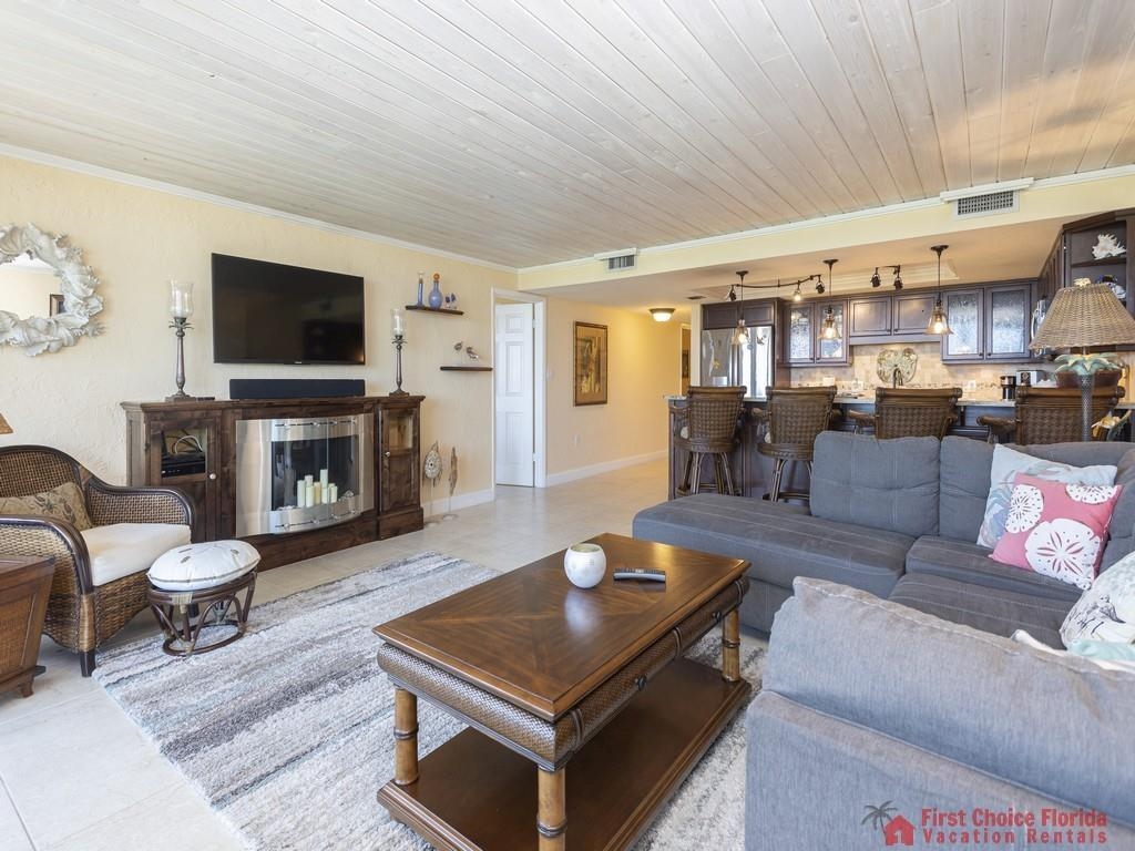 1 Dondanville Road, Unit 109B St. Augustine, FL 32080 - Photo 3 of 27 a living room with furniture a flat screen tv and a fireplace