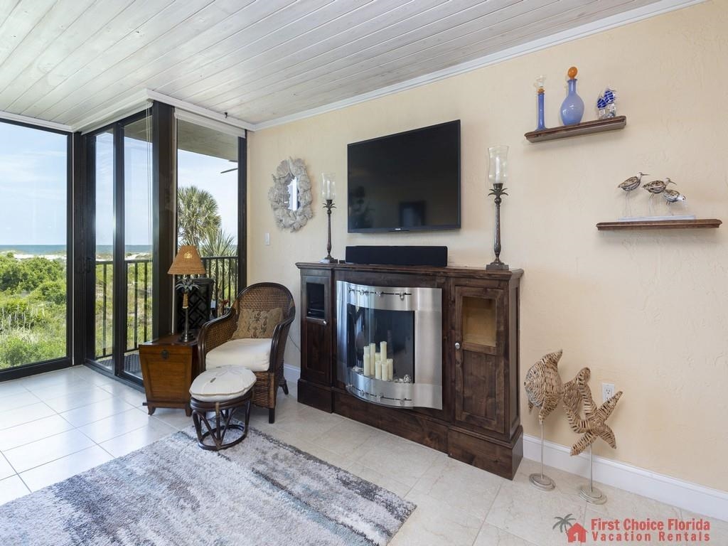 1 Dondanville Road, Unit 109B St. Augustine, FL 32080 - Photo 6 of 27 a living room with furniture a fireplace and a flat screen tv